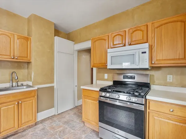 a kitchen with stainless steel appliances granite countertop a stove and a sink