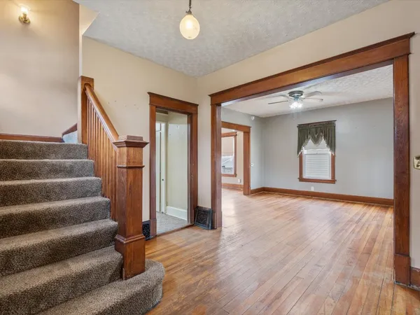 a view of an entryway with wooden floor and stairs