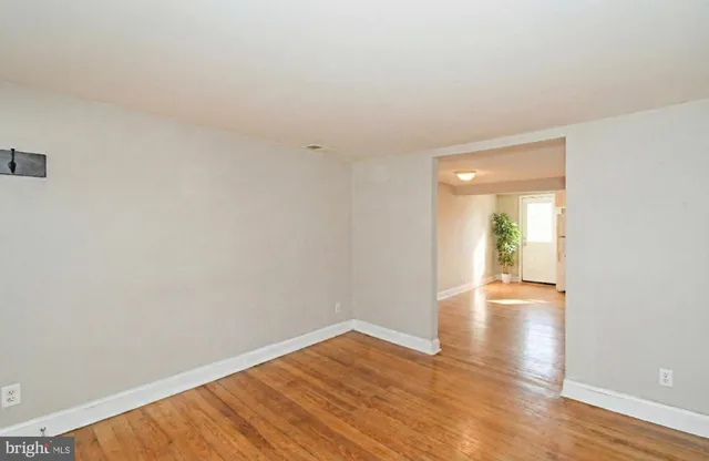 a view of an empty room and wooden floor