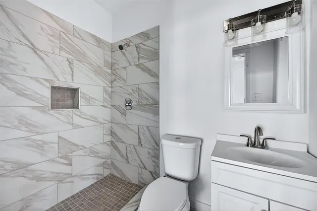a bathroom with a toilet sink and shower