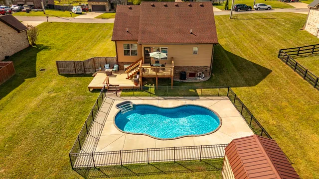 a swimming pool with some tall trees