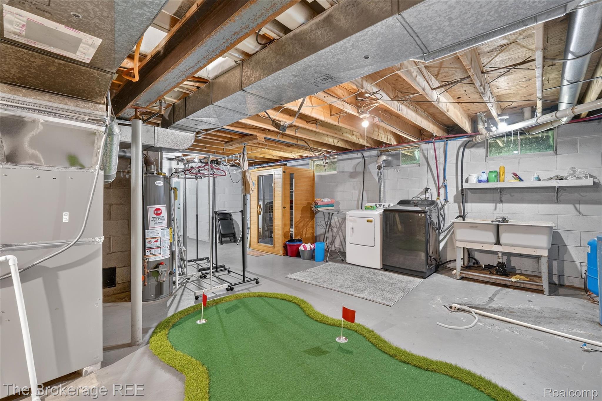 13269 North Genesee Road Clio, MI 48420 - Photo 45 of 67 Basement utility area featuring a dual laundry sink, exposed ductwork, and concrete block walls