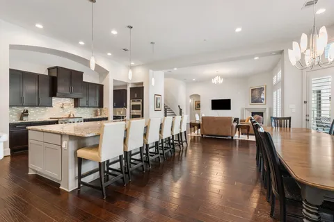 a large kitchen with a table and chairs