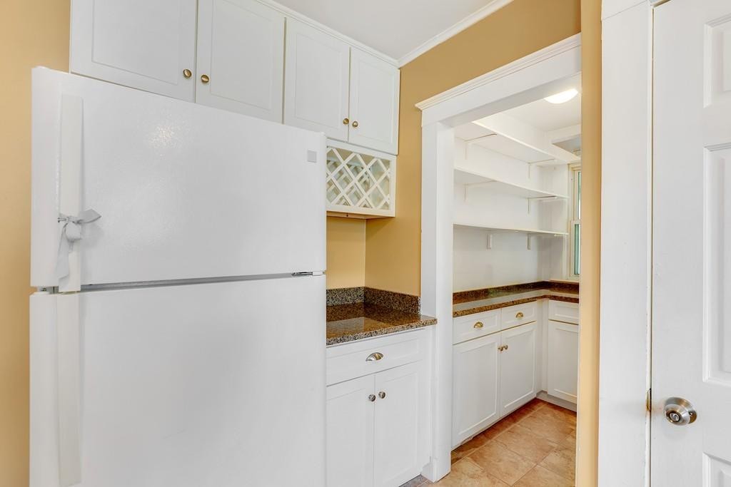 79 Ripley Street, Unit 79 Newton, MA 02459 - Photo 5 of 18 a white refrigerator freezer sitting inside of a kitchen