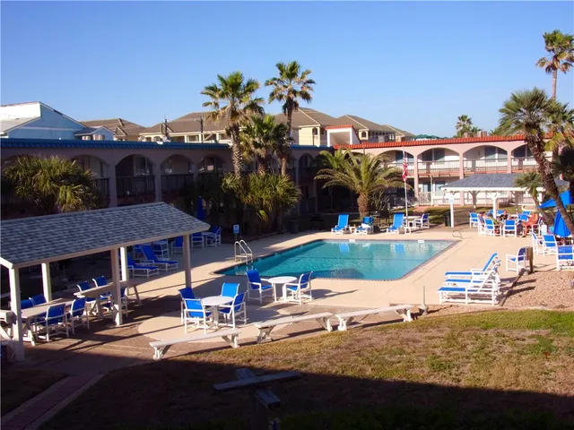 a living room with furniture and a painting on the wall