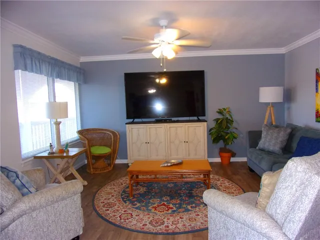 a living room with furniture and wooden floor