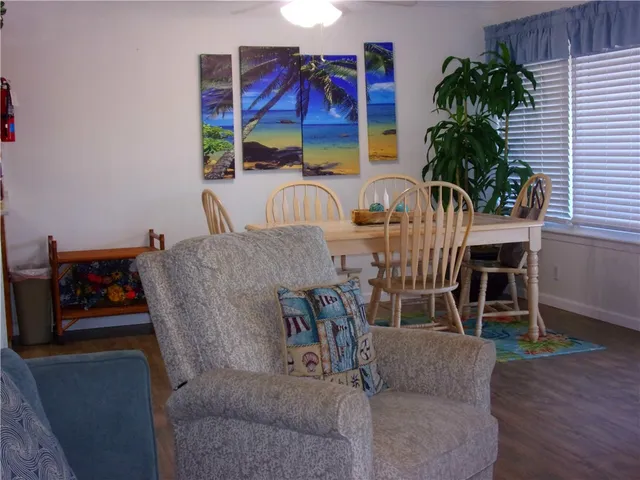 a view of dinning table and chairs in a room