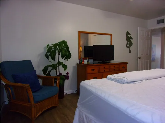 a bedroom with a bed and a wall painting