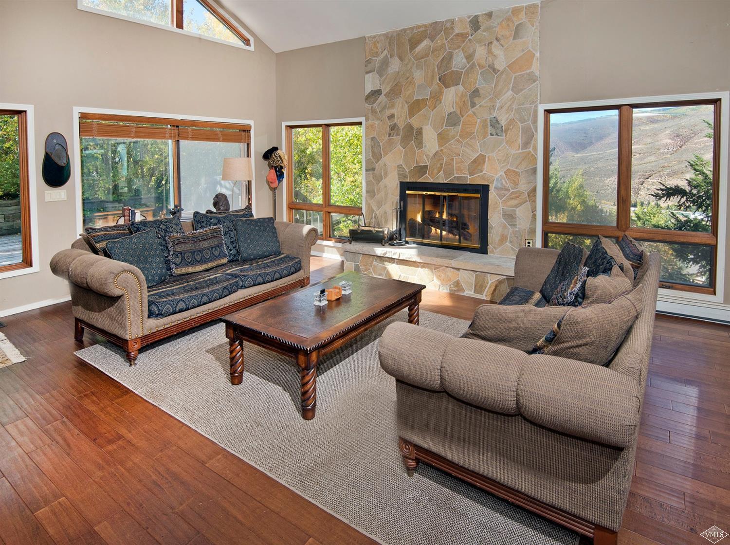 972 Eagle Drive Avon, CO 81620 - Photo 1 of 25 a living room with furniture a fireplace and a floor to ceiling window