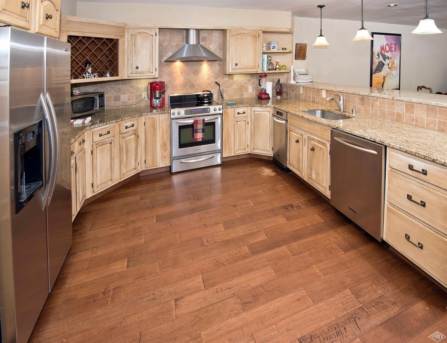 972 Eagle Drive Avon, CO 81620 - Photo 11 of 25 a kitchen with granite countertop a sink stove and refrigerator