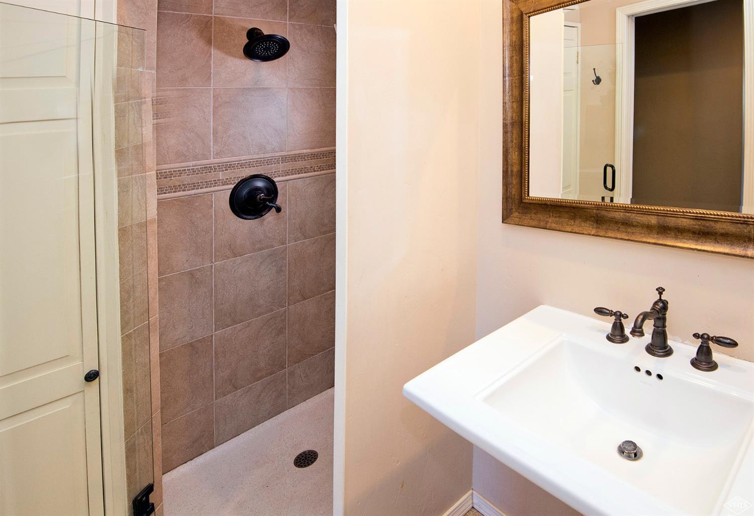 972 Eagle Drive Avon, CO 81620 - Photo 15 of 25 a bathroom with a sink a mirror and shower