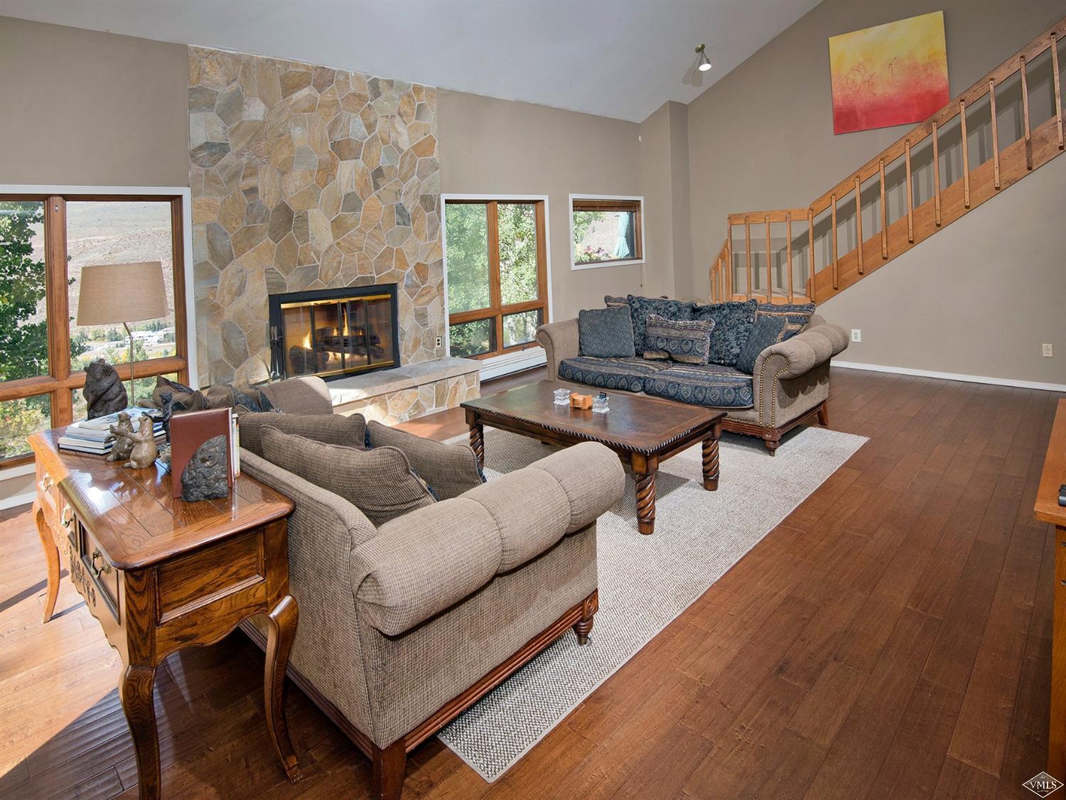 972 Eagle Drive Avon, CO 81620 - Photo 2 of 25 a living room with furniture a fireplace and a large window