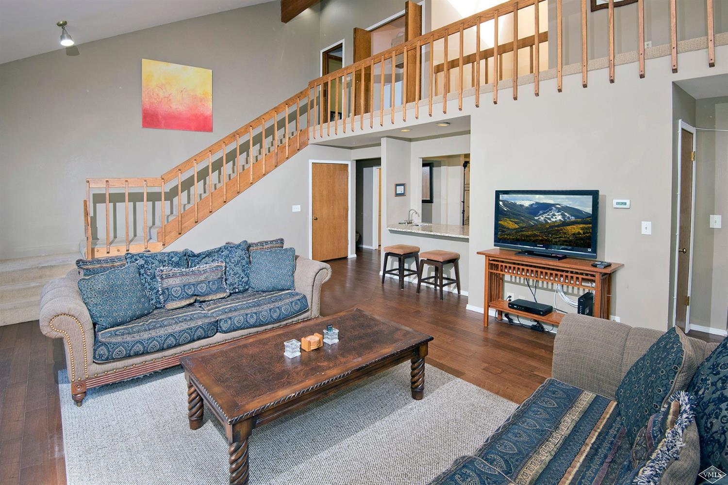 972 Eagle Drive Avon, CO 81620 - Photo 7 of 25 a living room with furniture a flat screen tv and a dining table