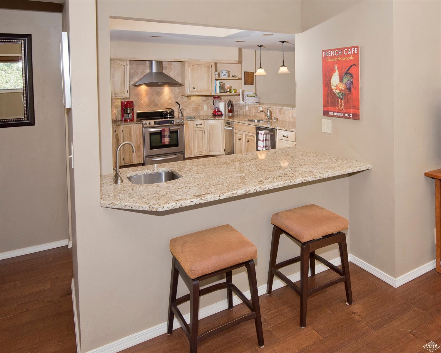 972 Eagle Drive Avon, CO 81620 - Photo 10 of 25 a kitchen with stainless steel appliances granite countertop a sink and cabinets