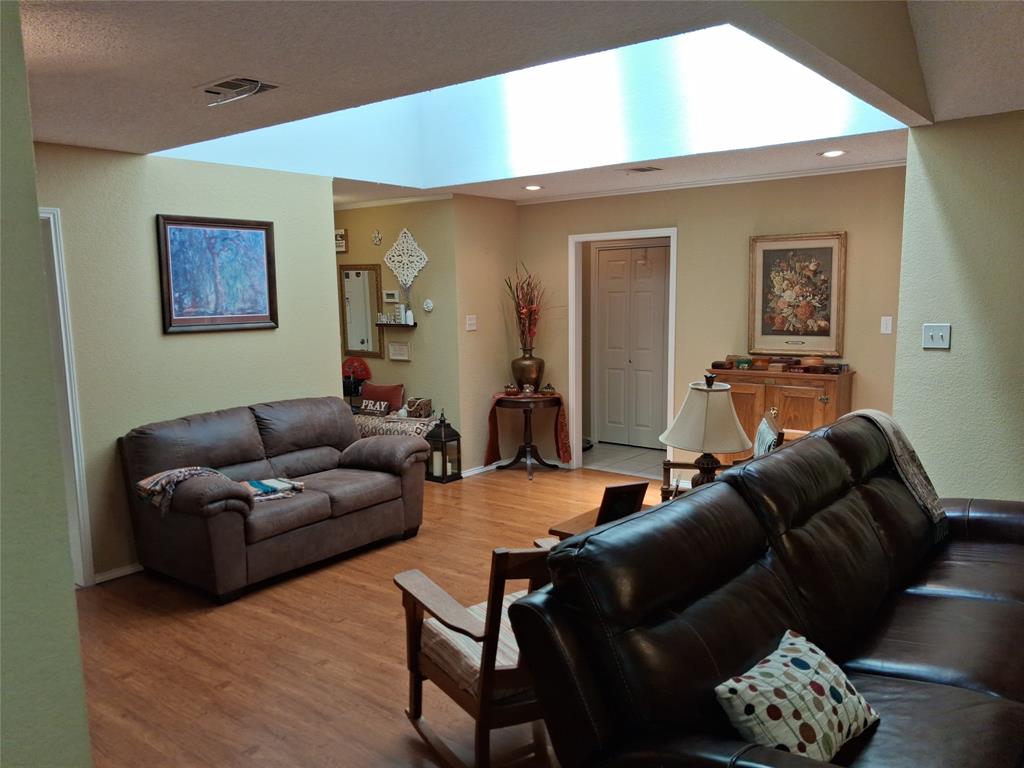 3600 Fox Ridge Road Lorena, TX 76655 - Photo 7 of 31 Living area featuring a prominent skylight, wood-finish flooring, and recessed lighting