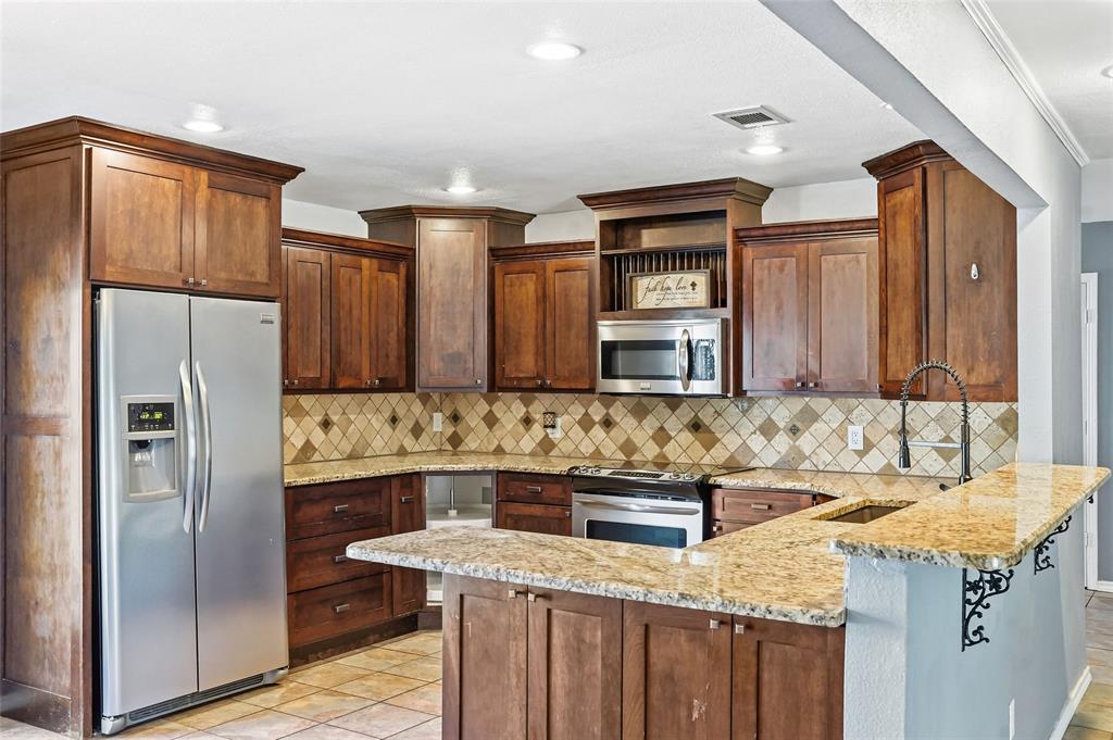 1325 Carter Street Sulphur Springs, TX 75482 - Photo 1 of 31 a kitchen with stainless steel appliances granite countertop a sink stove and refrigerator