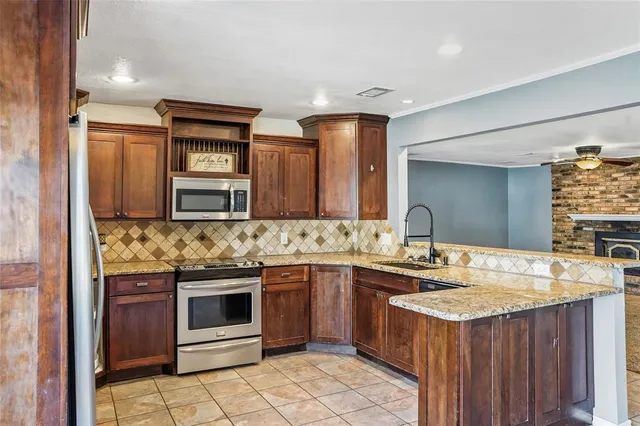a kitchen with a stove sink and cabinets