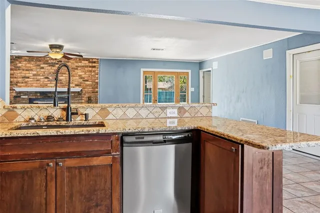 a kitchen with granite countertop a sink and a window