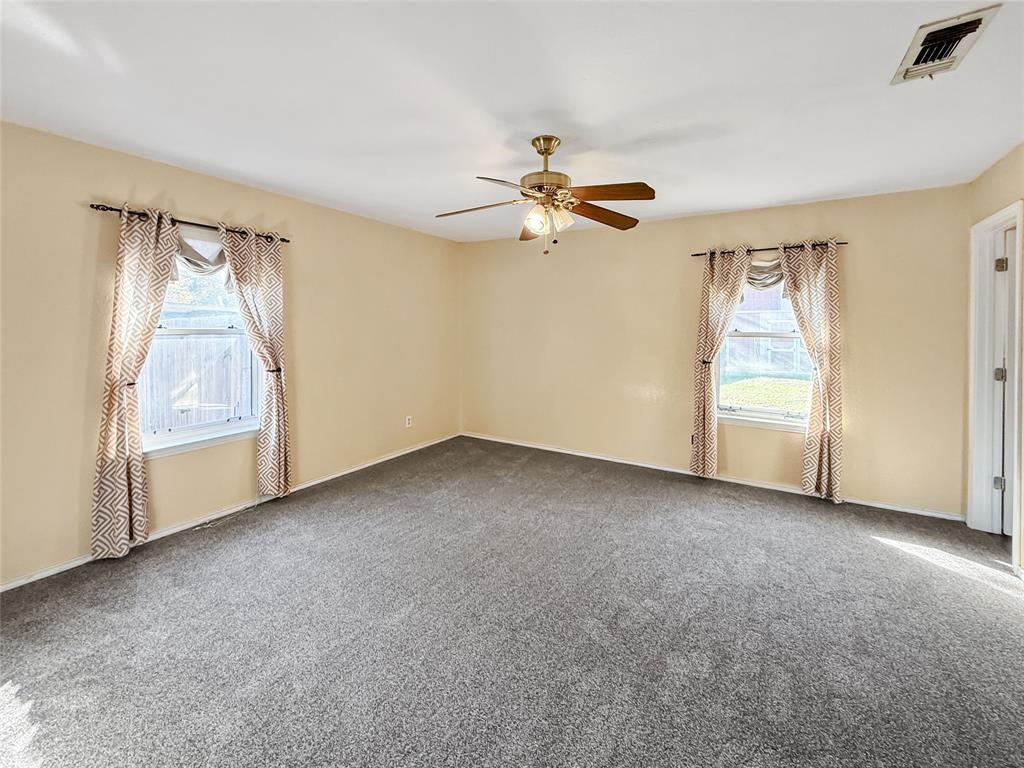 1325 Carter Street Sulphur Springs, TX 75482 - Photo 21 of 31 an empty room with windows and fan