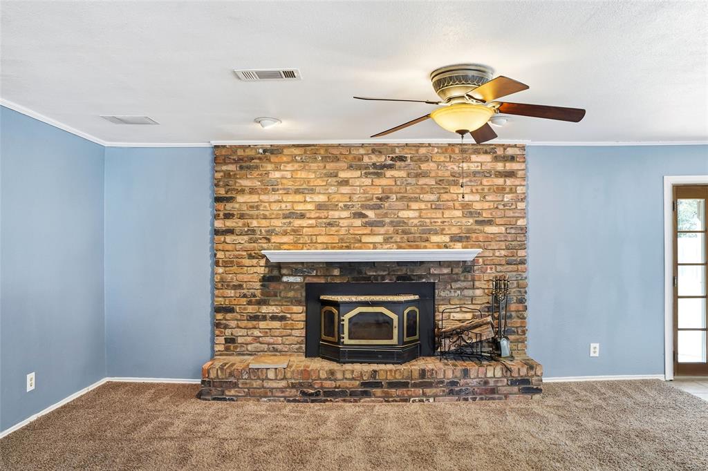 1325 Carter Street Sulphur Springs, TX 75482 - Photo 7 of 31 a living room with a fireplace