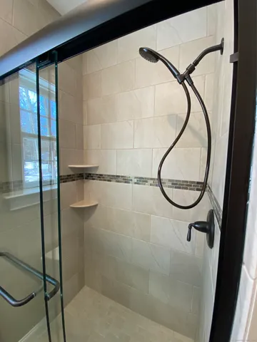 a bathroom with a glass shower door