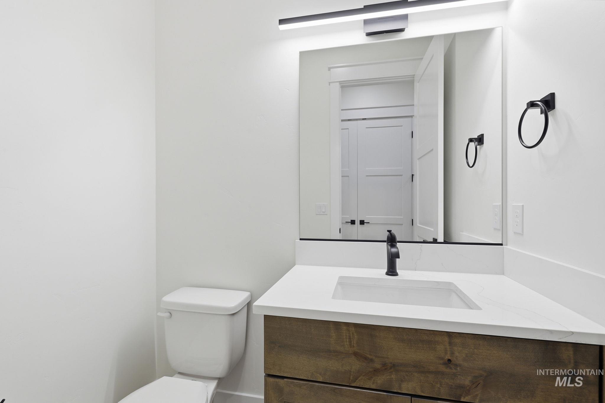 2321 Lower Bluff Road Emmett, ID 83617 - Photo 21 of 31 Room featuring two large windows, wood-finish flooring, a contemporary ceiling fan, recessed lighting, and white baseboards