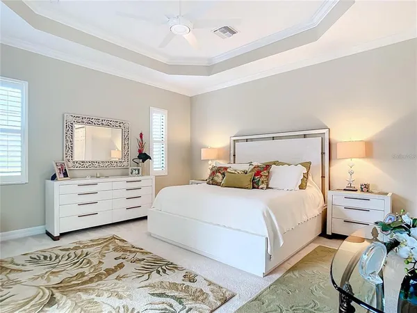 a living room with patio furniture and a floor to ceiling window