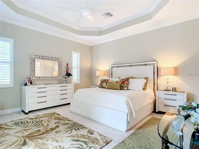 a living room with patio furniture and a floor to ceiling window