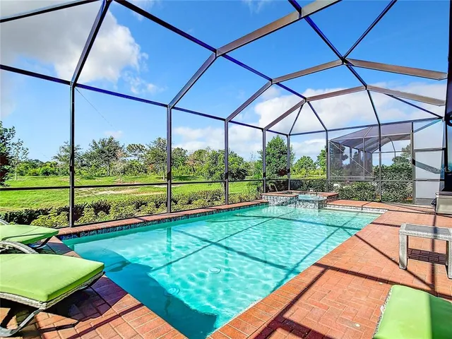 a view of a workspace with furniture and a flat screen tv