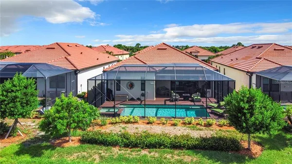 a view of a house with backyard porch and sitting area