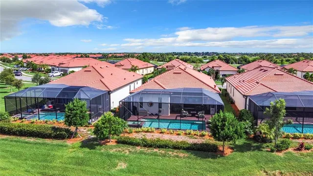 an aerial view of a house with a garden and lake view