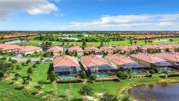 an aerial view of a house with a garden and lake view