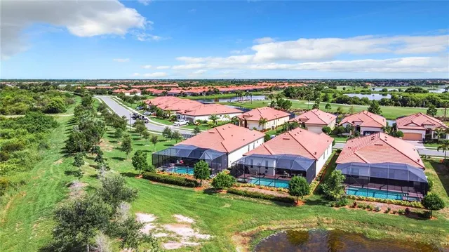 an aerial view of residential houses with outdoor space