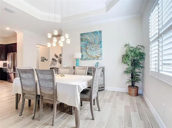 a view of a dining room with furniture and a chandelier