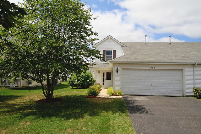 3709 Harms Road Joliet, IL 60435 - Photo 2 of 18 a front view of a house with a yard and garage
