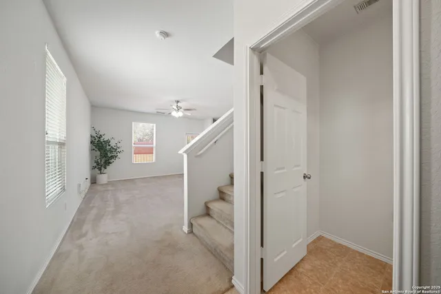 a view of a hallway view with staircase