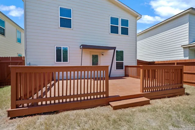 a view of a house with wooden fence
