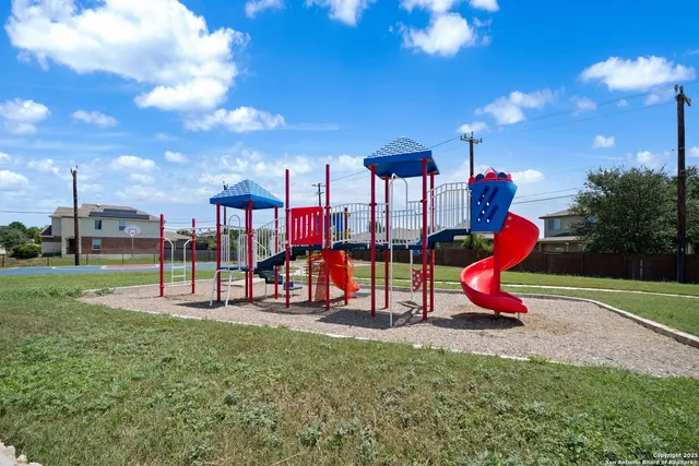 a view of a park with swings and slides