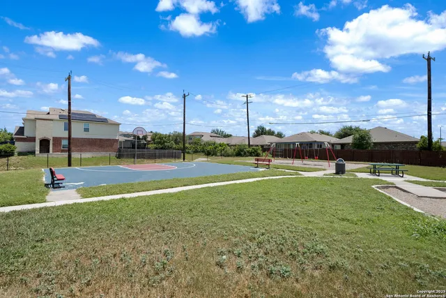 a view of a playground with basketball court