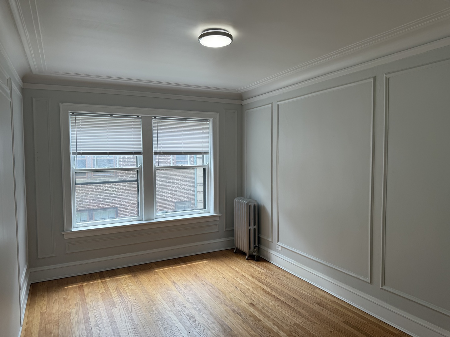 624 Sheridan Road, Unit 2 Evanston, IL 60202 - Photo 5 of 7 an empty room with wooden floor and windows