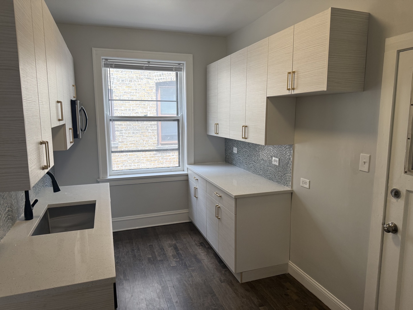 624 Sheridan Road, Unit 2 Evanston, IL 60202 - Photo 7 of 7 a kitchen with a sink a window and cabinets