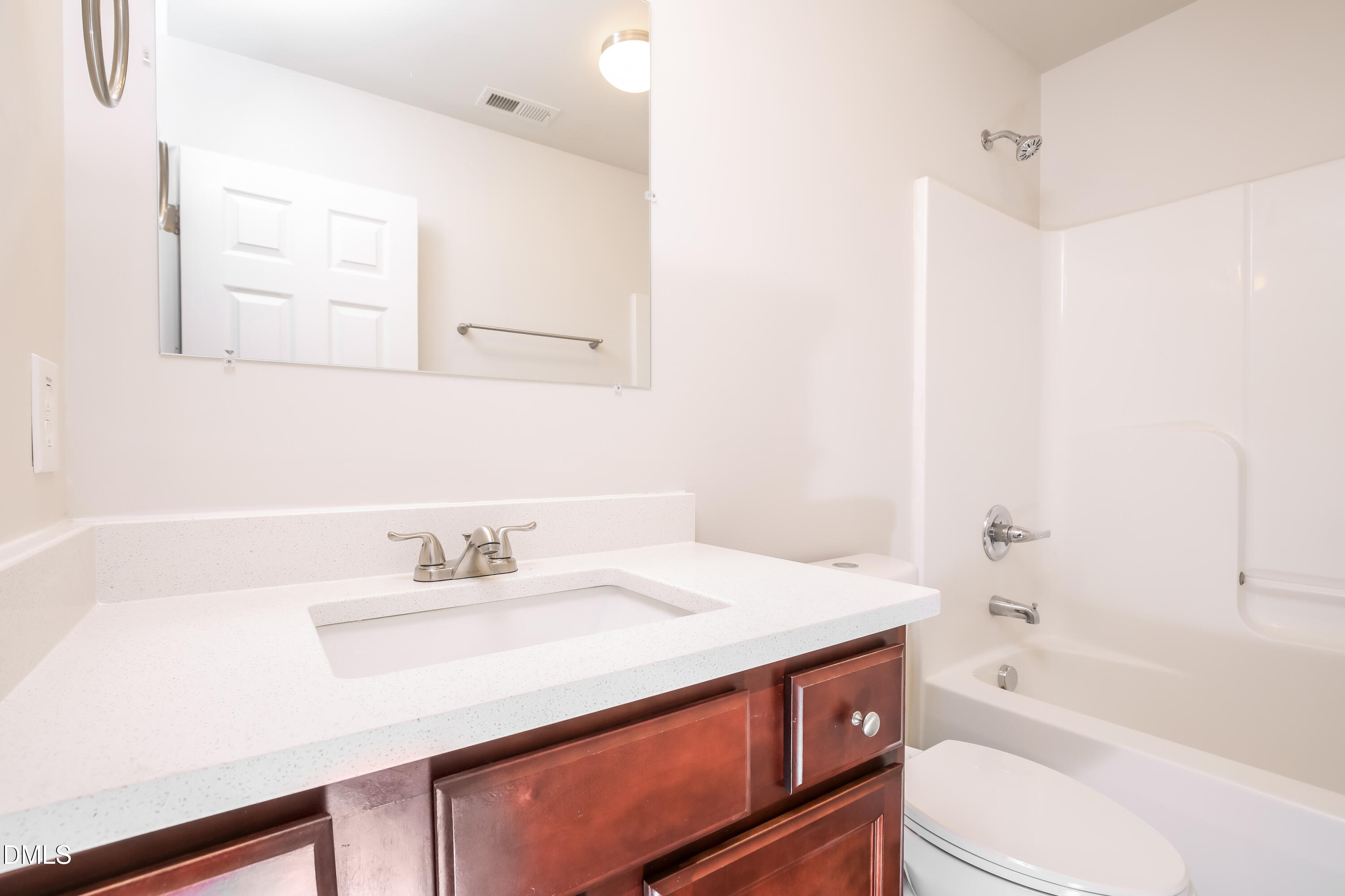 195 Cherryhill Drive Four Oaks, NC 27524 - Photo 13 of 17 a bathroom with a sink a toilet and bathtub