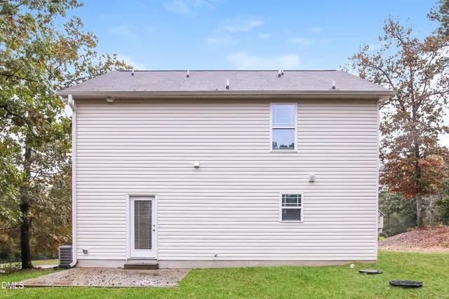 a view of a house with a yard and garage
