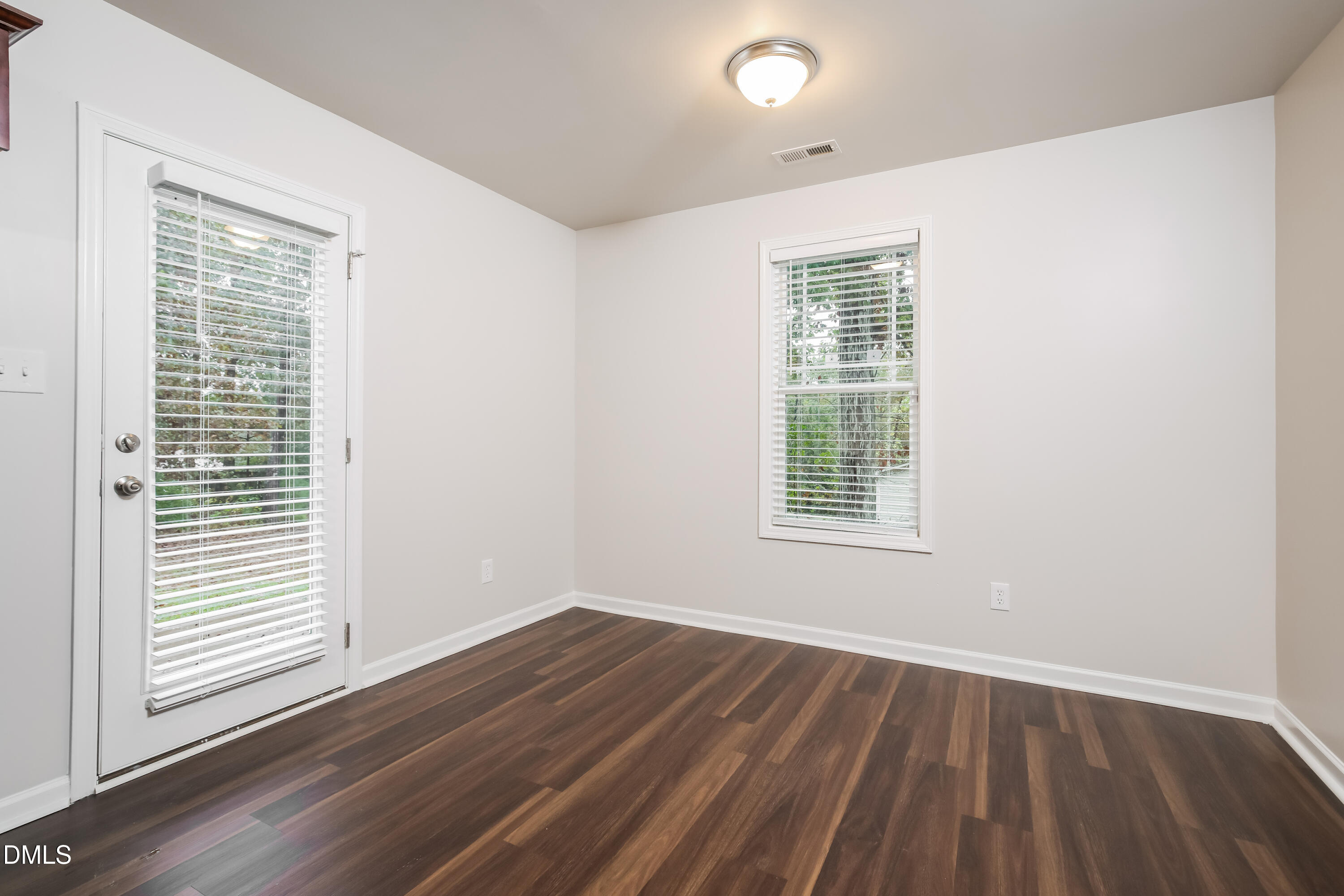 195 Cherryhill Drive Four Oaks, NC 27524 - Photo 4 of 17 a view of an empty room with wooden floor and a window
