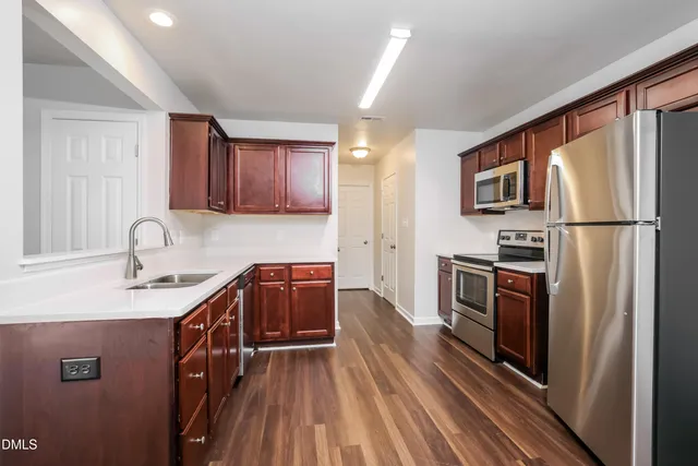 a kitchen with a refrigerator stove and sink