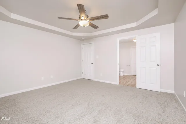 an empty room with a ceiling fan and a ceiling fan