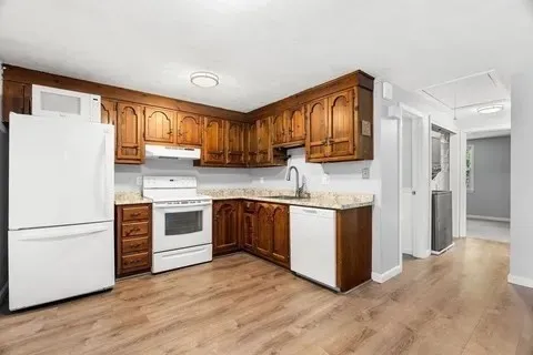 a kitchen with a refrigerator stove top oven and sink