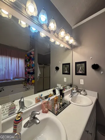 a bathroom with a sink a toilet a mirror and tub