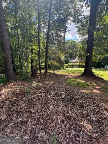 a view of a yard with large trees