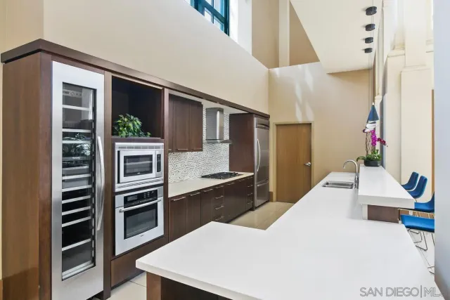 a kitchen with a dining table chairs and white cabinets